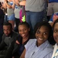 group of people smile at the football game